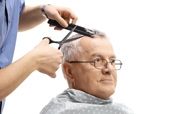 Senior client getting scissor cut