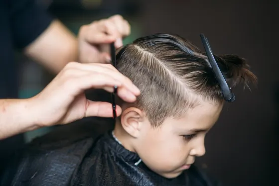 Child getting a side-part haircut