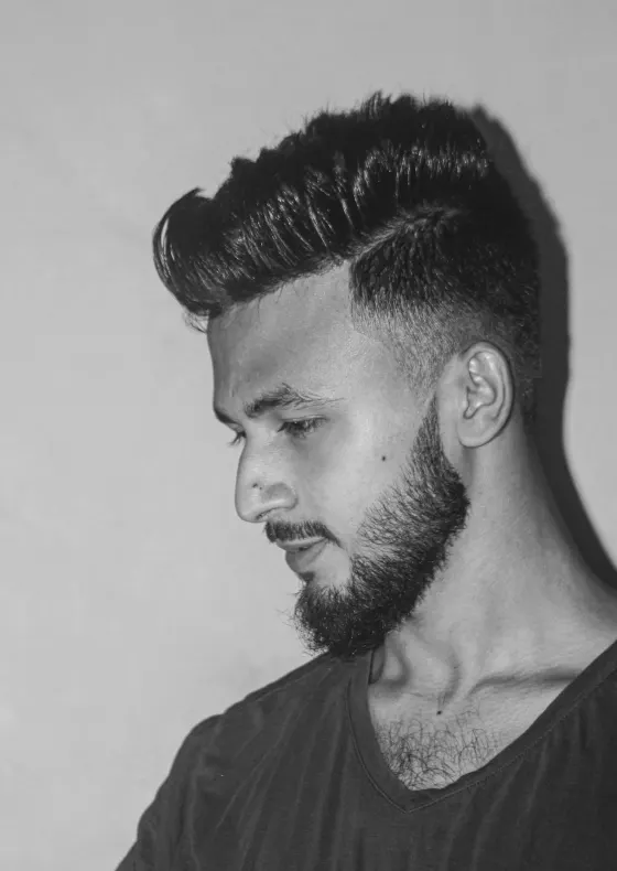 Black and white shot of a man with a sharp fade