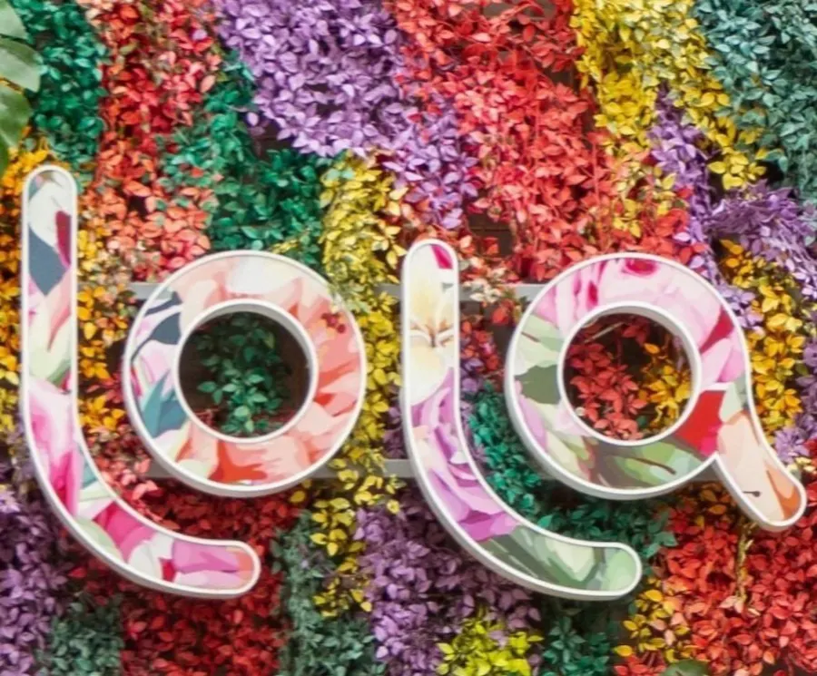 The flower-covered Lola sign at the salon